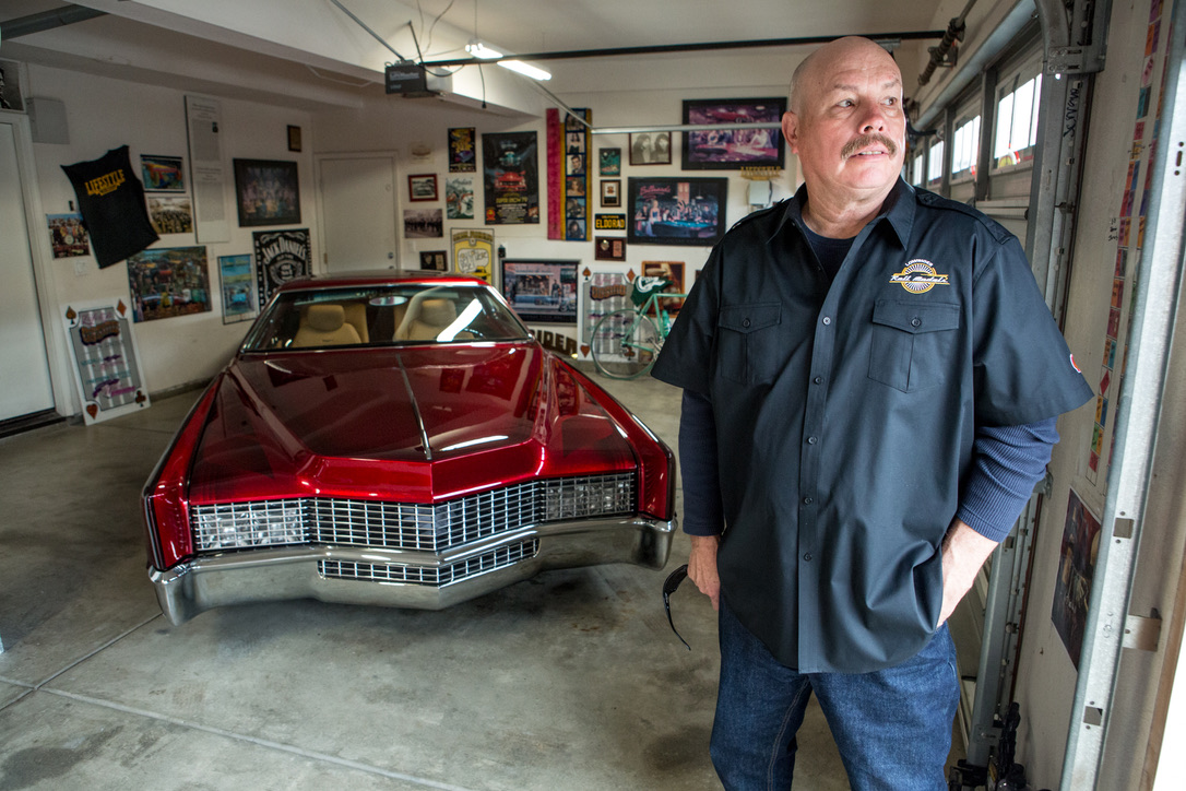 PORTRAIT — BUILDER BESIDE HIS CANDY RED '67 ELDORADO