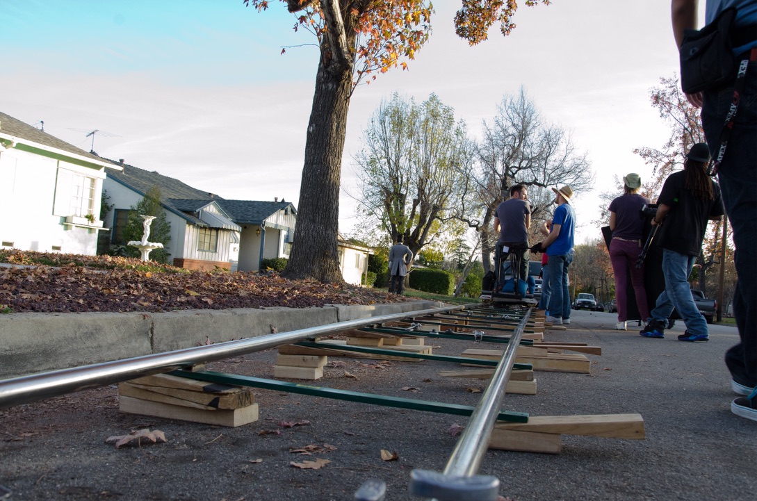 LAYING DOLLY TRACK DOWN THE STREET AT GOLDEN HOUR