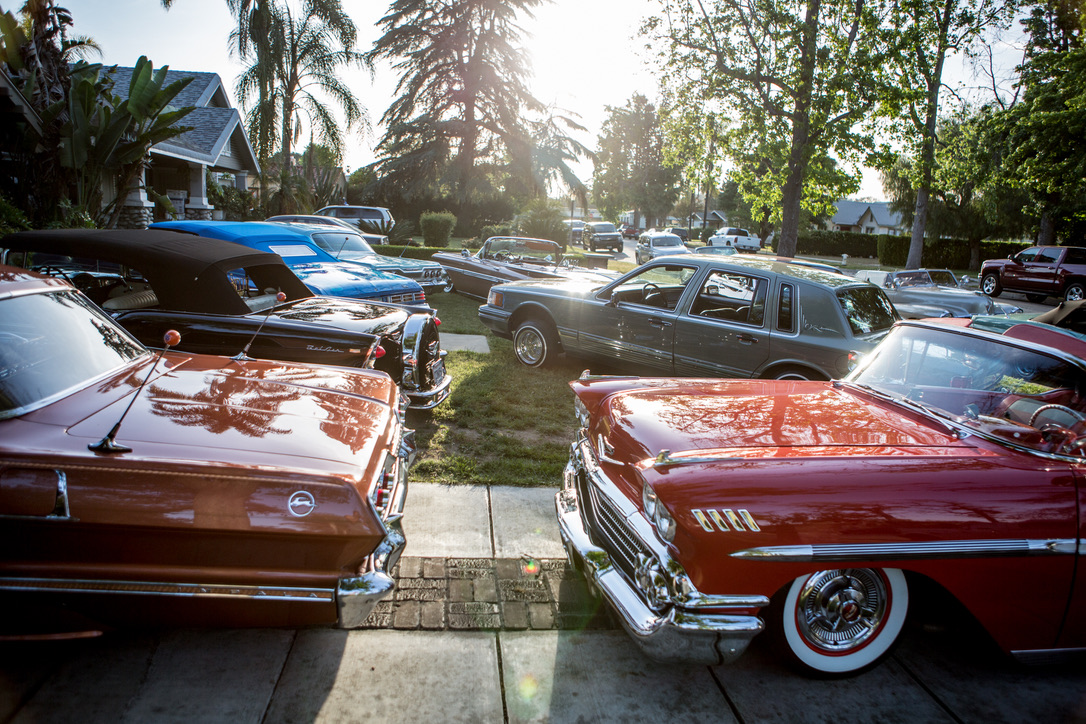 GOLDEN HOUR — CLUB CARS LINED UP ALONG THE FRONT LAWN