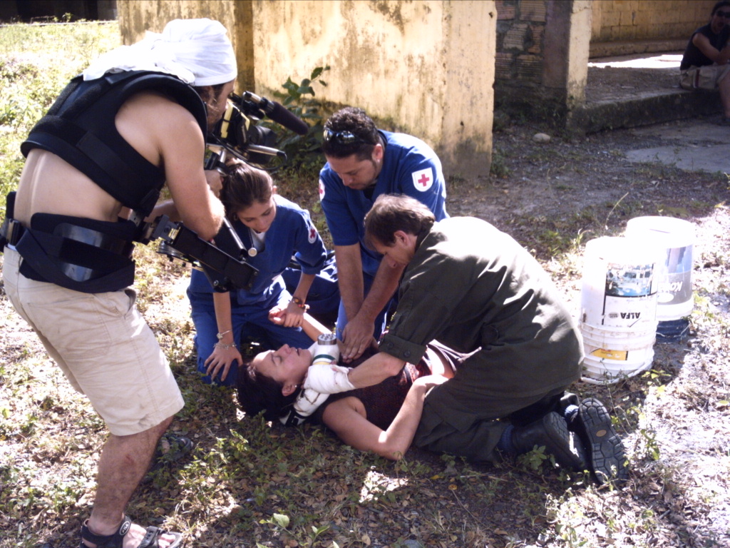 DIRECTOR SPIROS STATHOULOPOULOS STAGES THE GROUND SEQUENCE WITH THE CAST AND CREW.