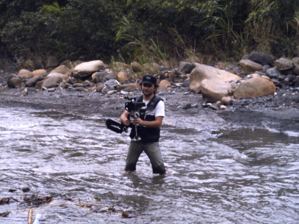 DIRECTOR SPIROS STATHOULOPOULOS WADES THE RIVER TO OPERATE THE STEADICAM RIG HIMSELF.